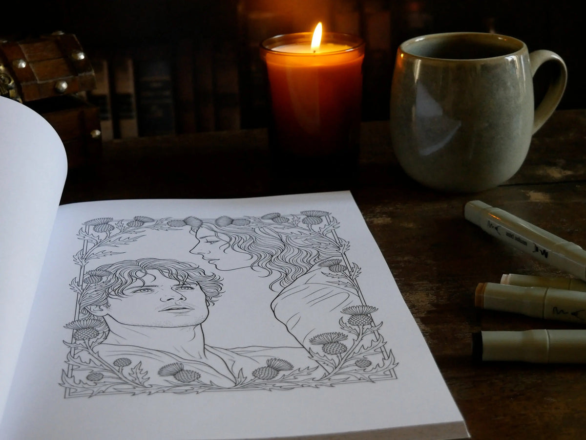 Page de coloriage : portrait d'un homme et d'une femme de profil dans un cadre orné de chardons, avec feutres, bougie et tasse
